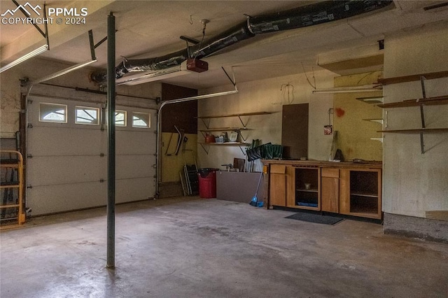 garage with a workshop area and a garage door opener