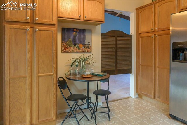 kitchen featuring stainless steel refrigerator with ice dispenser