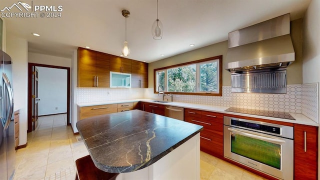 kitchen featuring light tile patterned flooring, stainless steel appliances, a center island, decorative backsplash, and wall chimney range hood