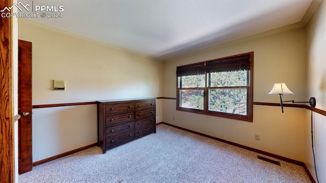 bedroom with crown molding and light colored carpet