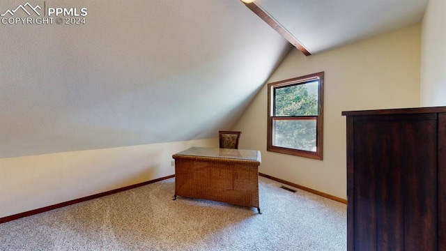 carpeted home office featuring vaulted ceiling