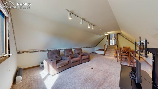 living room featuring track lighting, lofted ceiling, and carpet floors