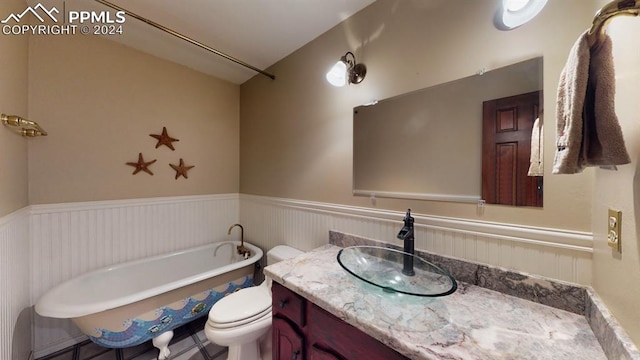 bathroom with toilet, a bathing tub, and vanity