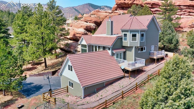 rear view of house featuring a deck with mountain view