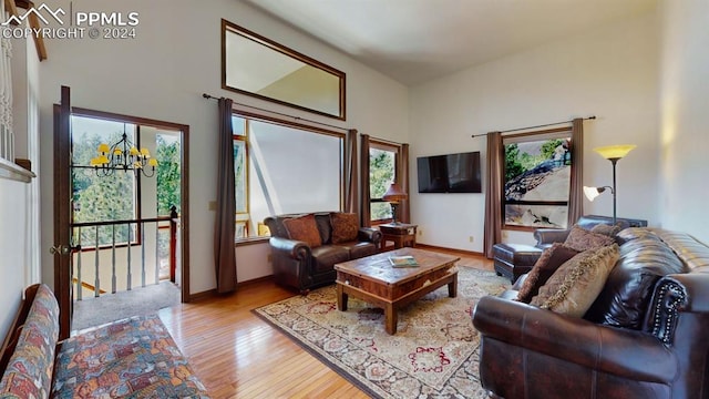 living room featuring a notable chandelier and light hardwood / wood-style flooring