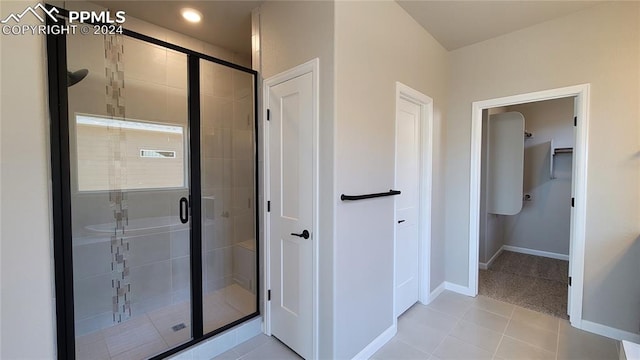 bathroom with tile patterned flooring and a shower with door