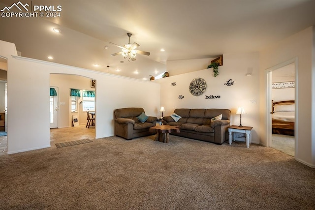 living room featuring ceiling fan, light colored carpet, and lofted ceiling