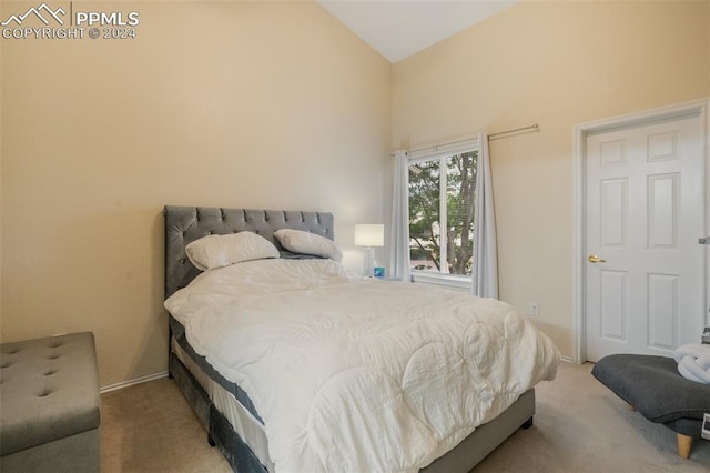 bedroom with carpet floors and vaulted ceiling