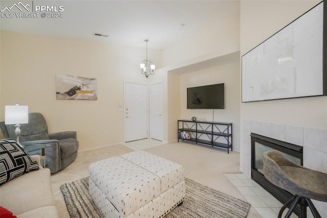 carpeted living room featuring a notable chandelier and a fireplace