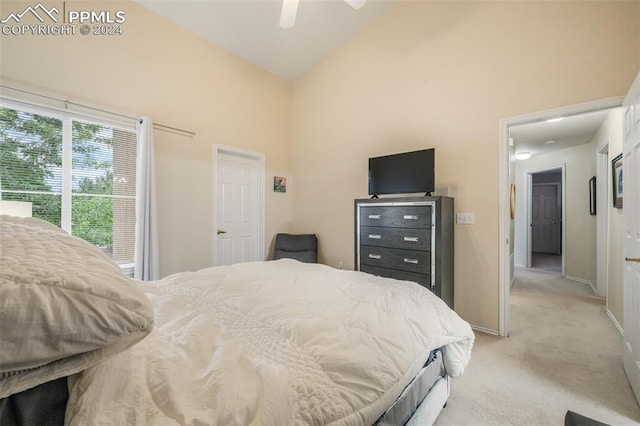 carpeted bedroom featuring ceiling fan and high vaulted ceiling