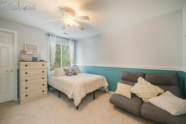 bedroom featuring light carpet and ceiling fan