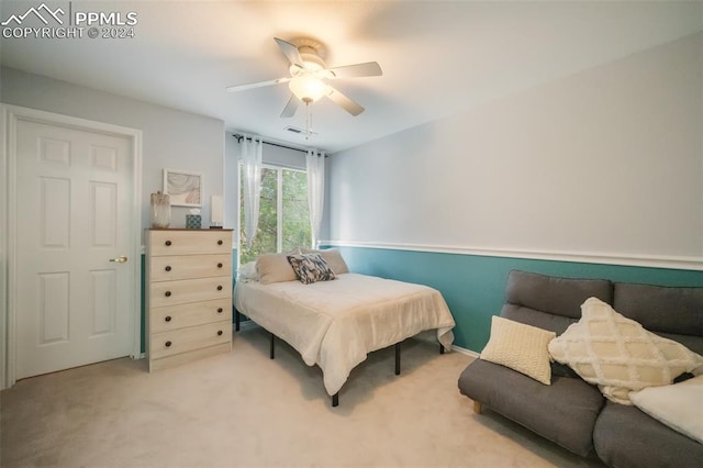 bedroom with light carpet and ceiling fan