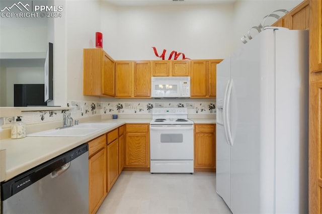 kitchen featuring white appliances, sink, and decorative backsplash