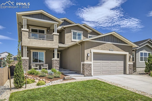 craftsman-style home featuring a balcony, a front lawn, and a garage