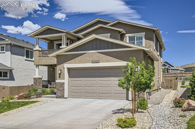 view of front of property with a balcony and a garage