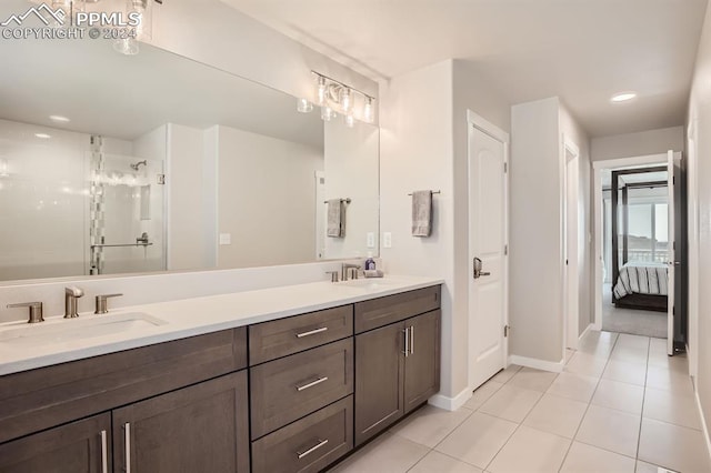 bathroom featuring walk in shower, vanity, and tile patterned flooring