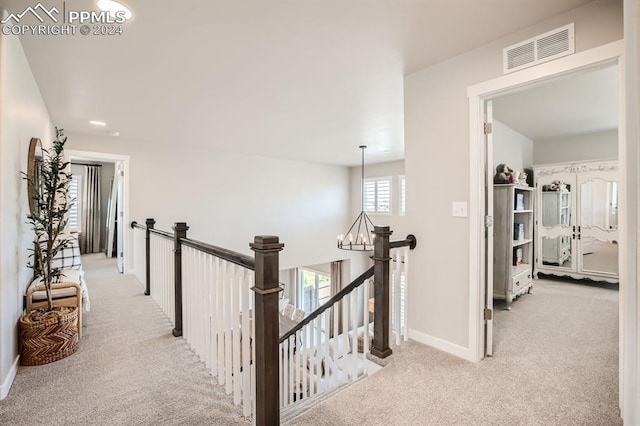 hall featuring light colored carpet