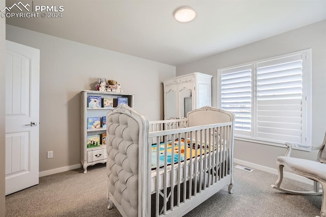 bedroom with carpet and a crib