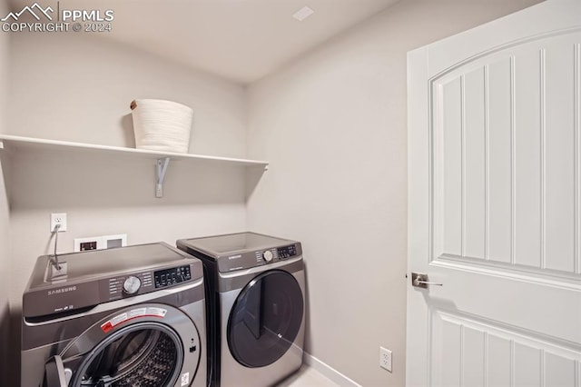 clothes washing area with washing machine and clothes dryer