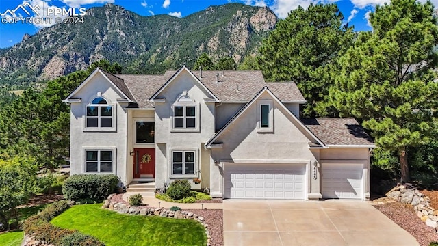 view of front of home featuring a mountain view and a garage