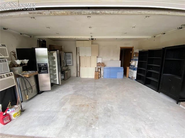 garage with stainless steel fridge with ice dispenser