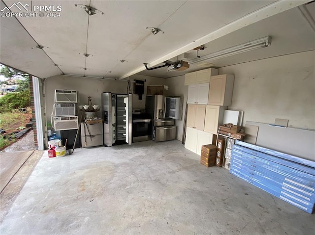 garage featuring stainless steel fridge with ice dispenser and a garage door opener