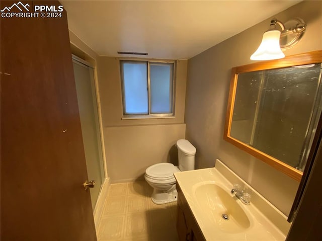 bathroom featuring tile patterned floors, vanity, and toilet