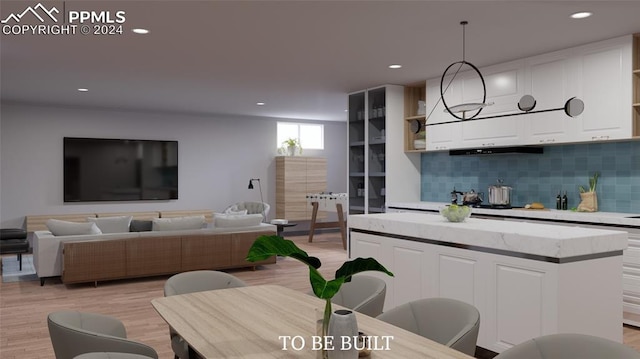 kitchen featuring pendant lighting, white cabinets, decorative backsplash, light hardwood / wood-style flooring, and exhaust hood