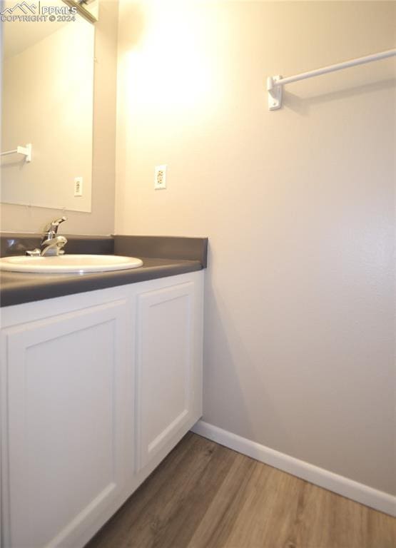 bathroom with vanity and hardwood / wood-style floors