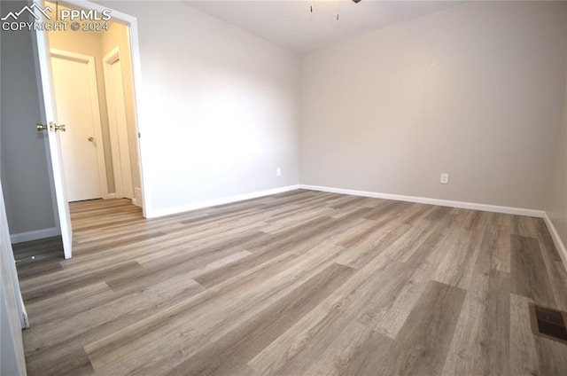 spare room featuring light hardwood / wood-style floors and ceiling fan