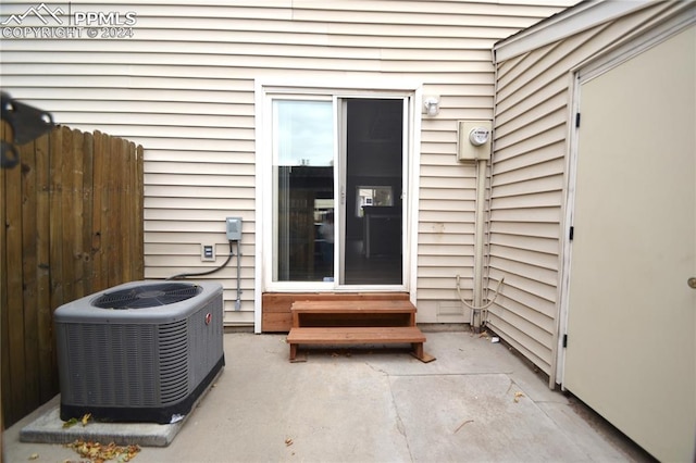 entrance to property with a patio and central AC unit