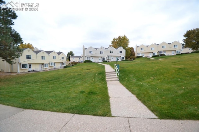 view of home's community with a yard