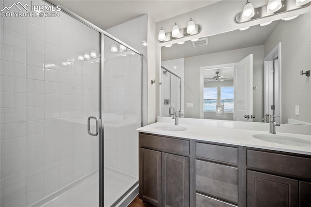 bathroom featuring ceiling fan, walk in shower, and vanity