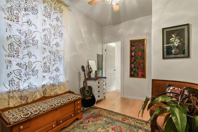 living area with light hardwood / wood-style flooring and ceiling fan