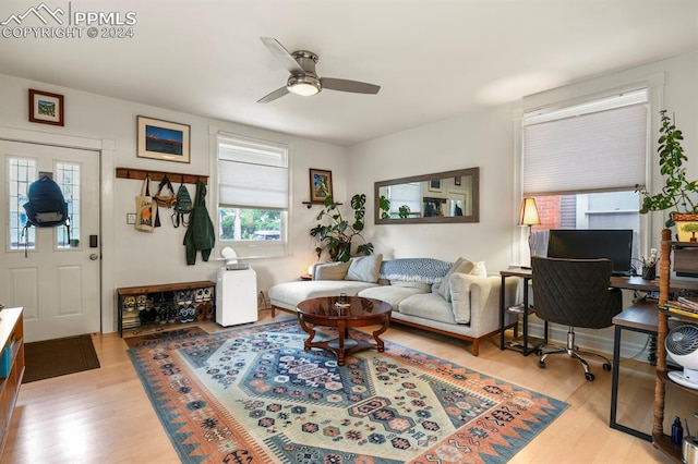 living room featuring light hardwood / wood-style flooring and ceiling fan