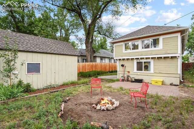 back of house featuring a fire pit and a patio