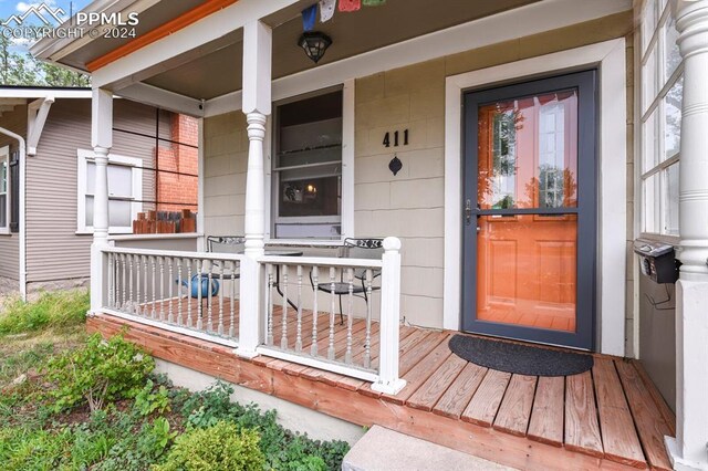 view of exterior entry featuring covered porch