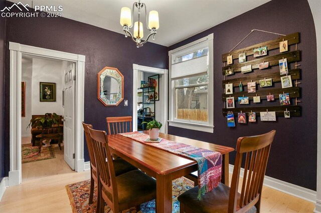 dining room featuring light hardwood / wood-style floors and a notable chandelier