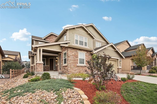 craftsman inspired home with covered porch and a garage