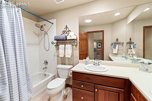 full bathroom with shower / bath combo with shower curtain, tile patterned floors, toilet, and vanity