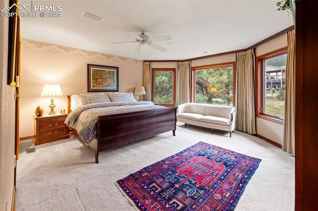 bedroom featuring crown molding, ceiling fan, and light colored carpet