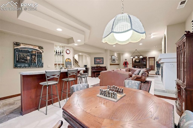 dining area with indoor bar and light tile patterned floors