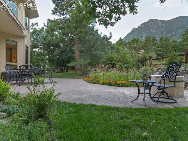 view of yard featuring a mountain view and a patio