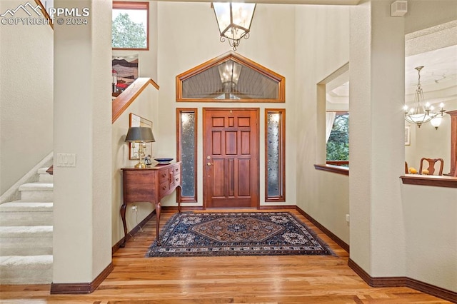 foyer featuring wood-type flooring and an inviting chandelier