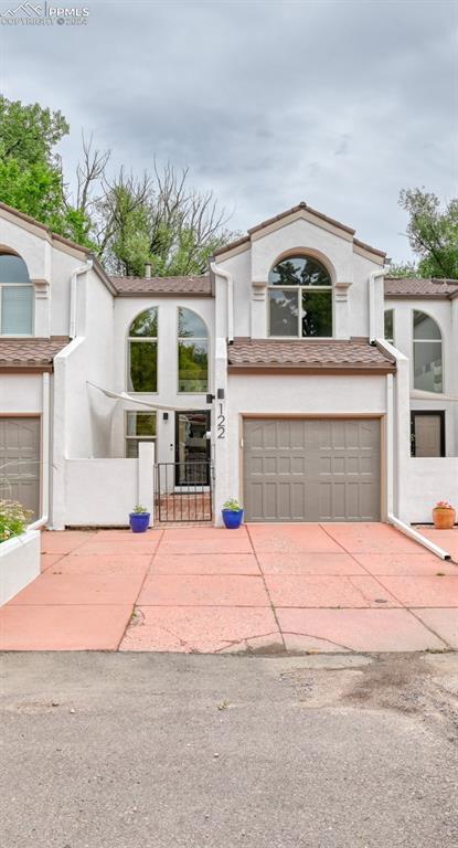 mediterranean / spanish home with a garage