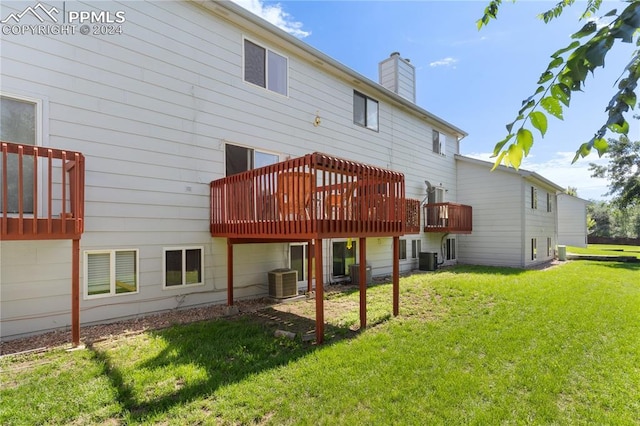 back of property featuring a deck, a yard, and central AC unit