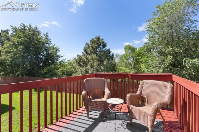 wooden deck with a lawn