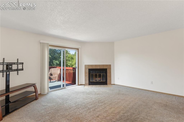 carpeted living room with a textured ceiling and a fireplace