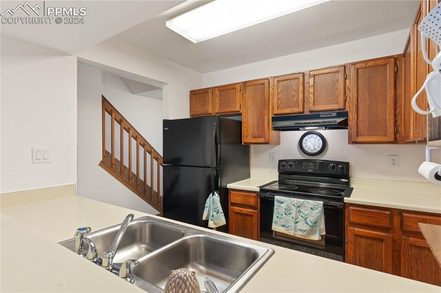 kitchen featuring sink and black appliances