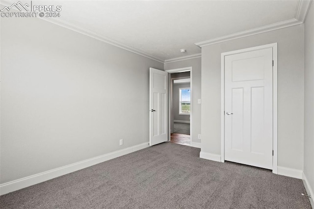 unfurnished bedroom with carpet flooring and crown molding